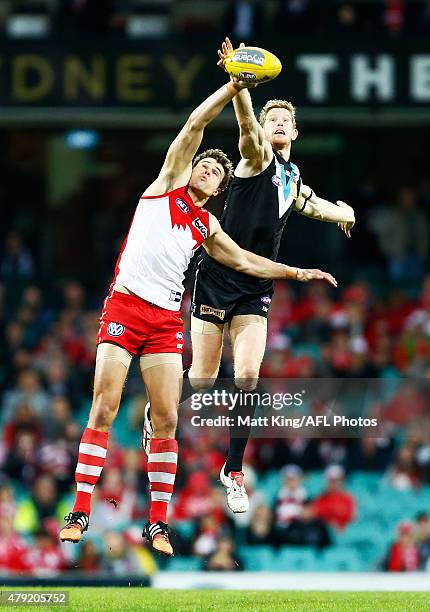 Mike Pyke of the Swans competes for the ball against Matthew Lobbe of the Power during the round 14 AFL match between the Sydney Swans and the Port...