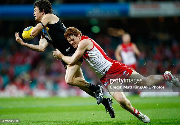 Jasper Pittard of the Power is tackled by Gary Rohan of the Swans as Rohan is injured during the round 14 AFL match between the Sydney Swans and the...