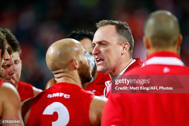 Swans head coach John Longmire speaks to his players at three quarter time during the round 14 AFL match between the Sydney Swans and the Port...