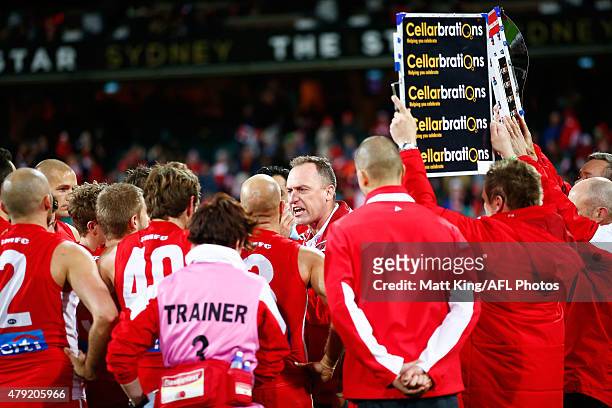 Swans head coach John Longmire speaks to his players at three quarter time during the round 14 AFL match between the Sydney Swans and the Port...