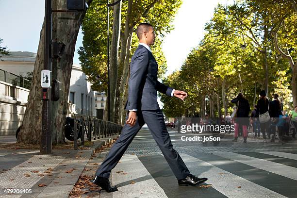 business man crossing the street, paris - pedestrian crossing man stock pictures, royalty-free photos & images