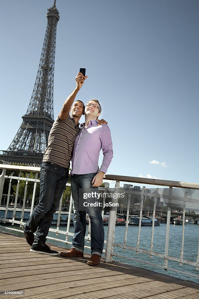 Couple taking picture with mobile phone, Paris