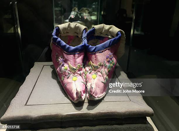 Tiny pair of shoes made for a woman's bound feet sits on display at the Shu Embroidery Museum on June 28, 2015 in Chengdu, China. Foot binding to...