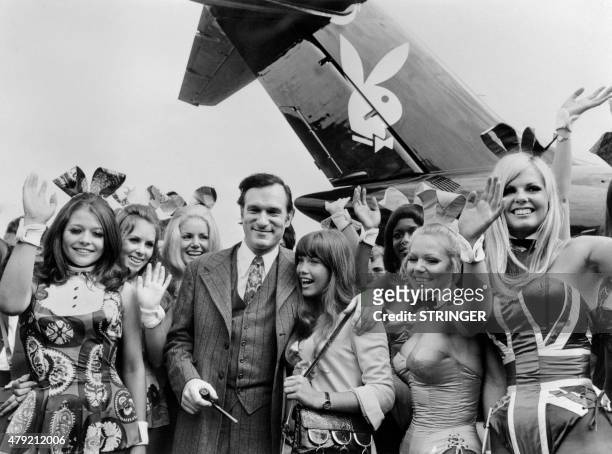 Photo taken on August 30, 1970 shows US Playboy Magazine publisher Hugh Hefner , his girlfriend actress Barbara Benton and other playmates arriving...