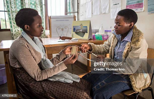 The young women Tharcille Niyonagira and Joselyne Mukamazimpaka discussing the use of different contraceptives at the Rubona health center on...