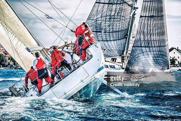 sailing crew on sailboat during regatta - sailing stockfoto's en -beelden