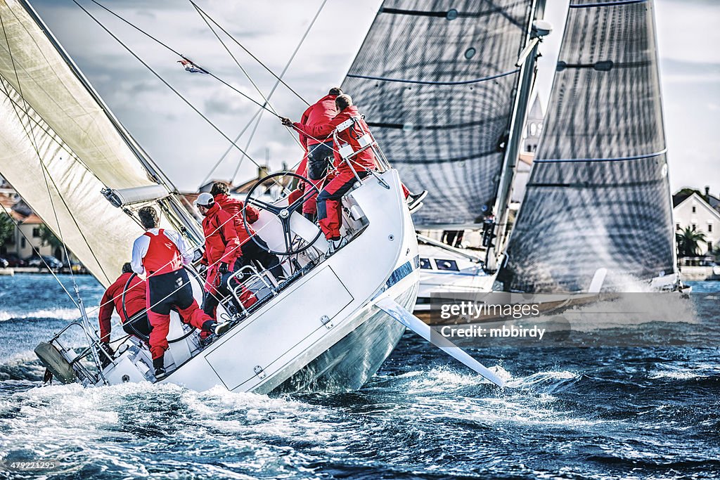 Sailing crew on sailboat during regatta