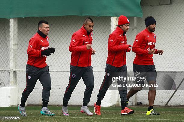 Chile's footballers Gary Medel, Arturo Vidal, Jorge Valdivia and Jean Beausejour jog during a training session at the Juan Pinto Duran sport complex...