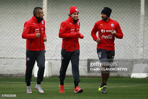 Chile's footballers Arturo Vidal, Jorge Valdivia and Jean Beausejour jog during a training session at the Juan Pinto Duran sport complex in Santiago,...