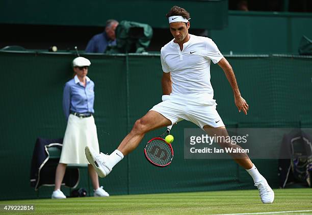 Roger Federer of Switzerland plays a whot through the legs during his Gentlemens Singles Second Round match against Sam Querry of the United States...