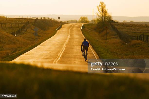 road bicycle ride - prairie silhouette stock pictures, royalty-free photos & images