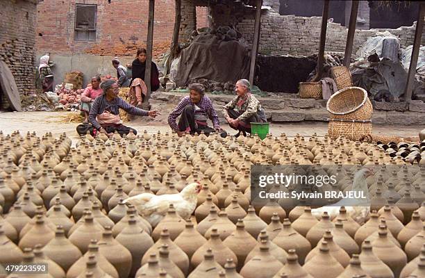 Nepalese women making some potteries, in the old city of Bhaktapur,Kathmandu Valley, Nepal.