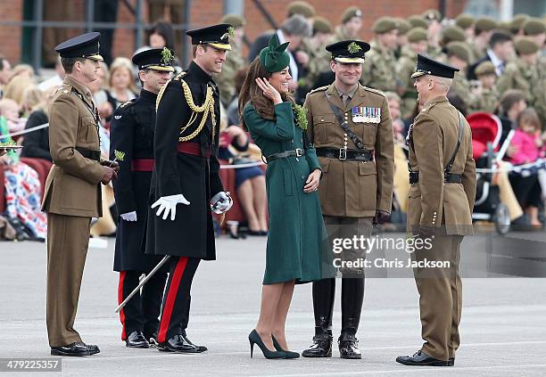 Catherine, Duchess of Cambridge and Prince William, Duke of Cambridge laugh as they present the 'Shamrocks' during the St Patrick's Day parade at...