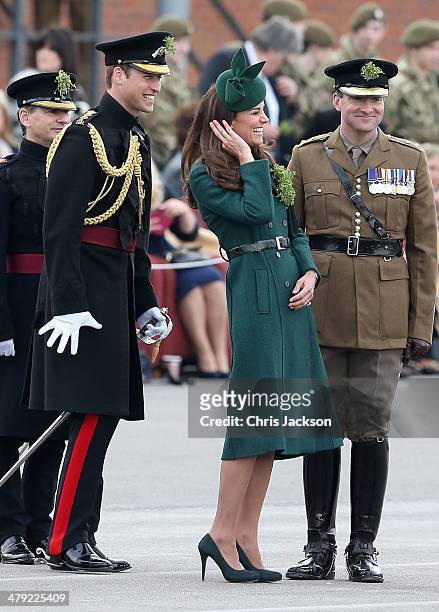 Catherine, Duchess of Cambridge and Prince William, Duke of Cambridge laugh as they present the 'Shamrocks' during the St Patrick's Day parade at...