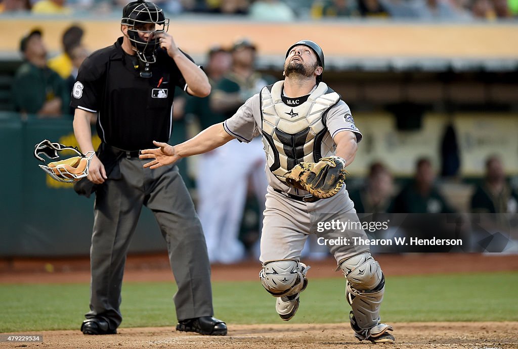 Mike Rokes Colorado Michael McKenry of the Colorado Rockies chases after a foul pop-up ...