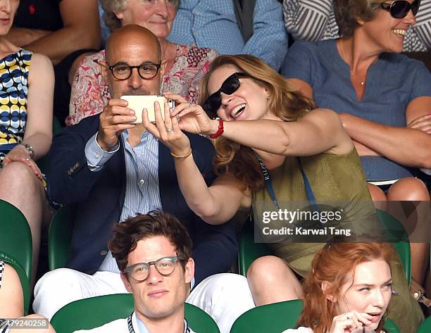 Stanley Tucci and Felicity Blunt attend the Sam Querry v Roger Federer match on day four of the Wimbledon Tennis Championships at Wimbledon on July...