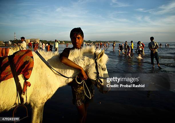 Portrait of a man who rents horses for rides at Coxs bazaar sea beach.