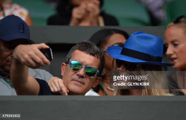 Spanish actor Antonio Banderas poses for a selfie with Nicole Kempel watching Spain's Rafael Nadal play against Germany's Dustin Brown during their...