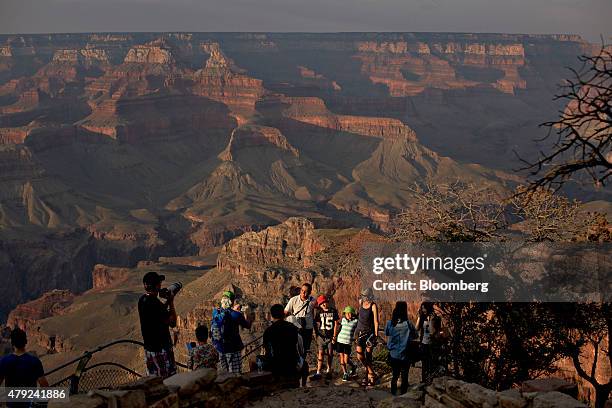 Visitors pose for photographs while standing on Hopi Point at Grand Canyon National Park in Grand Canyon, Arizona, U.S., on Wednesday, June 24, 2015....