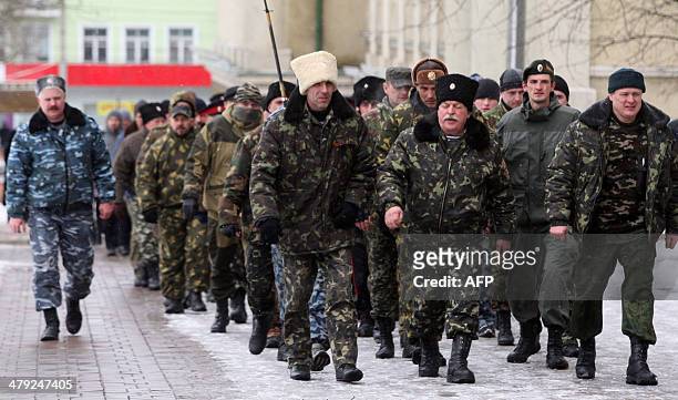 Cossacks, pro-Russian activists, march to take part in a rally outside the regional state administration building in Donetsk, eastern Ukraine, on...