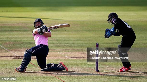 Paul Stirling of Middlesex hits out while Sussex's Craig Cachopa looks on during the NatWest T20 Blast match between Middlesex and Sussex at Lord's...