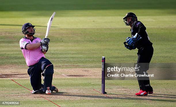 Paul Stirling of Middlesex hits out while Sussex's Craig Cachopa looks on during the NatWest T20 Blast match between Middlesex and Sussex at Lord's...