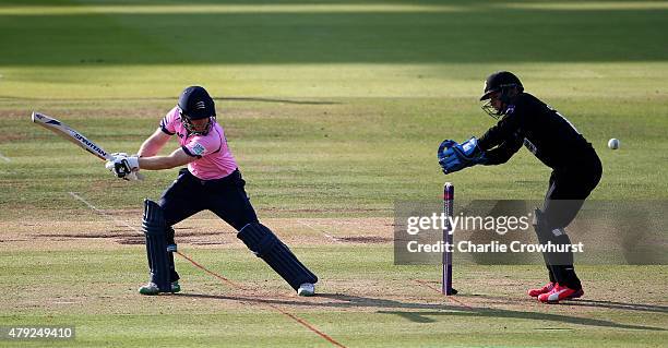 Eoin Morgan of Middlesex hits out while Craig Cachopa of Sussex looks on during the NatWest T20 Blast match between Middlesex and Sussex at Lord's...