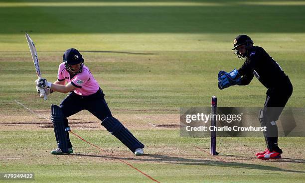 Eoin Morgan of Middlesex hits out while Craig Cachopa of Sussex looks on during the NatWest T20 Blast match between Middlesex and Sussex at Lord's...