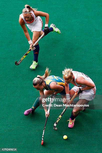 Jacky Schoenaker and Margot Van Geffen of the Netherlands battle for the ball with Emily Smith of Australia during the Fintro Hockey World League...