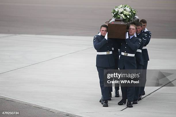 The coffin of Ann McQuire is taken from the RAF C-17 aircraft after it landed at RAF Brize Norton carrying nine of the victims of last Friday's...