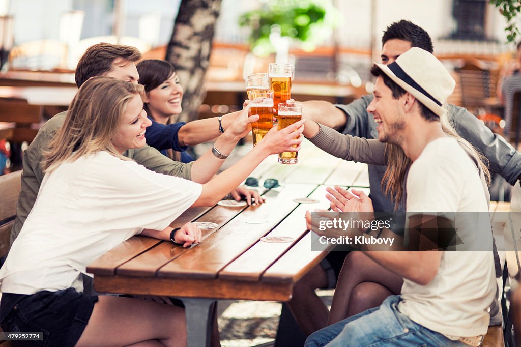 Young people drinking beer outdoors