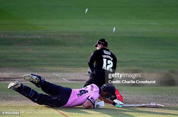 Craig Cachopa of Sussex smashes the bails off as Andrew Balbirnie of Middlesex is ran out during the NatWest T20 Blast match between Middlesex and...