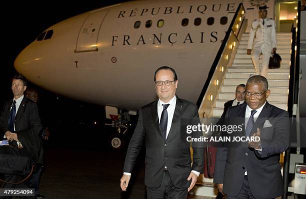 French President Francois Hollande is greeted by Angolese Foreign Minister Georges Rebelo Chicoti upon his arrival at Quatro de Fevereiro airport in...