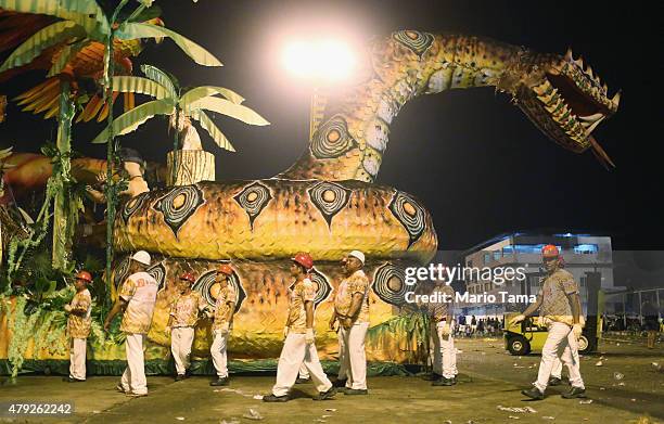 Participants walk past a snake float at the Parintins Folklore Festival in a town located along the Amazon River on June 27, 2015 in Parintins,...