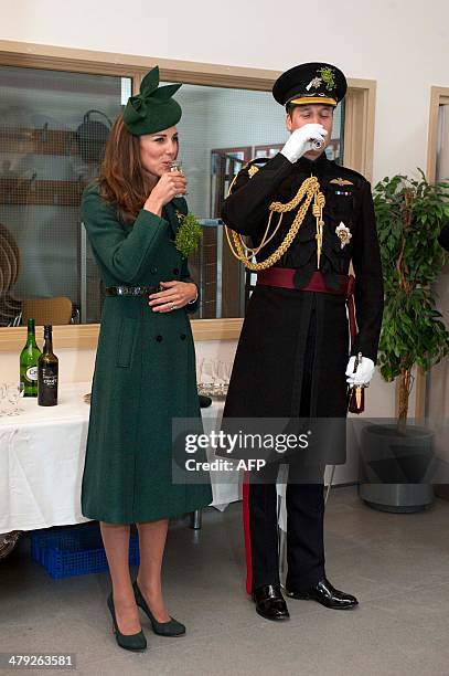 Britain's Prince William, the Duke of Cambridge and Catherine, Duchess of Cambridge drink a toast while visiting the Irish Guards during a St...