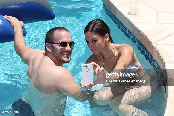 Actors Erik Aude and Erin O'Brien take a selfie as they attend a birthday party for former Major League Baseball player Jose Canseco on July 2, 2015...