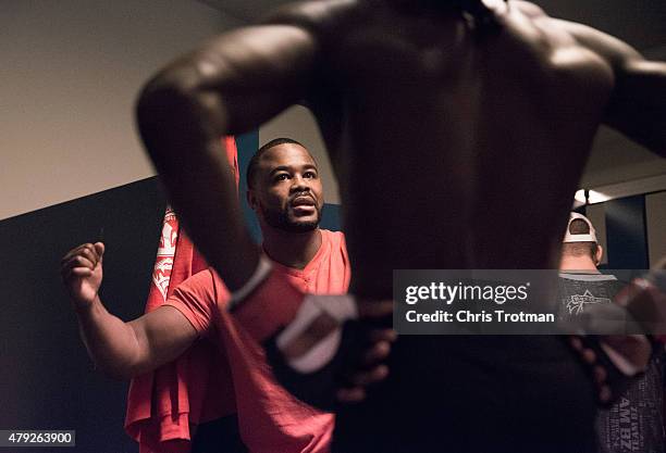 Blackzilian's teammate Rashad Evans talks with Jason Jackson while he warms up before facing Michael Graves during the filming of The Ultimate...