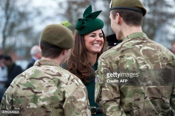 Catherine, Duchess of Cambridge speak with soldiers while visiting the Irish Guards during a St Patrick's Day parade in Mons Barracks in Aldershot on...