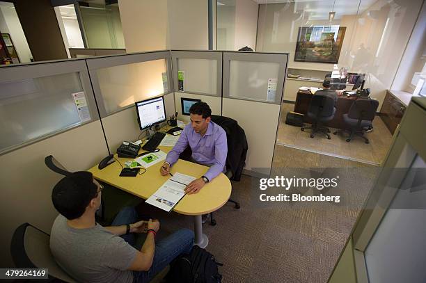 Tax advisor speaks with a customer at an H&R Block, Inc. Office in San Francisco, California, U.S., on Friday, March 14, 2014. The deadline for...