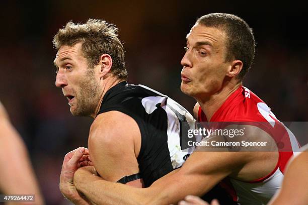 Jay Schulz of the Power is tackled by Ted Richards of the Swans during the round 14 AFL match between the Sydney Swans and the Port Adelaide Power at...