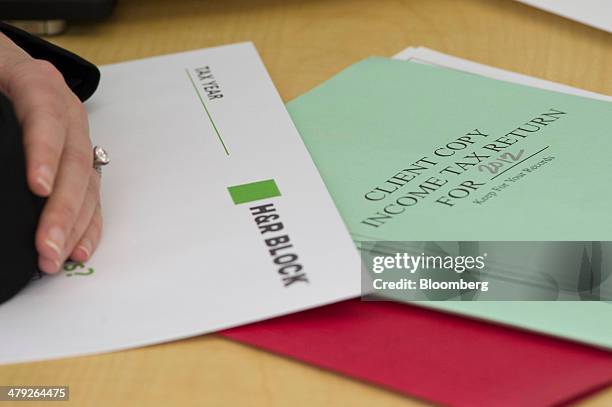 Tax forms sit on a desk at an H&R Block, Inc. Office in San Francisco, California, U.S., on Friday, March 14, 2014. The deadline for filing 2013 U.S....