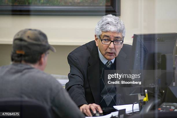 Tax advisor works with a customer at an H&R Block, Inc. Office in San Francisco, California, U.S., on Friday, March 14, 2014. The deadline for filing...