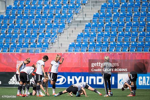 Germany's players stretch during a training session at the FIFA Women's World Cup in Edmonton, Canada on July 2, 2015. Germany meets England on...