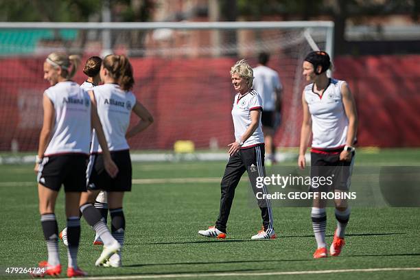 German head coach Silvia Neid looks on as her players warm up during a training session at the FIFA Women's World Cup in Edmonton, Canada on July 2,...