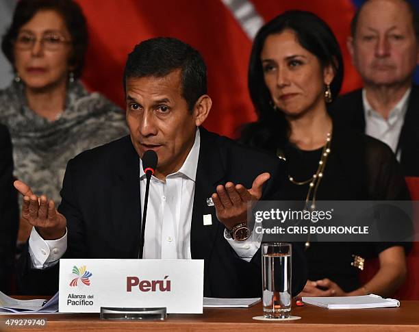 Peruvian President Olanta Humala, flanked by his wife Nadine Heredia , speaks during the inauguration of the 10th Pacific Alliance Summit, in...