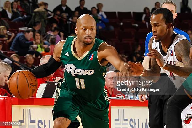 Sundiata Gaines of the Reno Bighorns moves the ball past Dee Bost of the Idaho Stampede during an NBA D-League game on March 15, 2014 at CenturyLink...