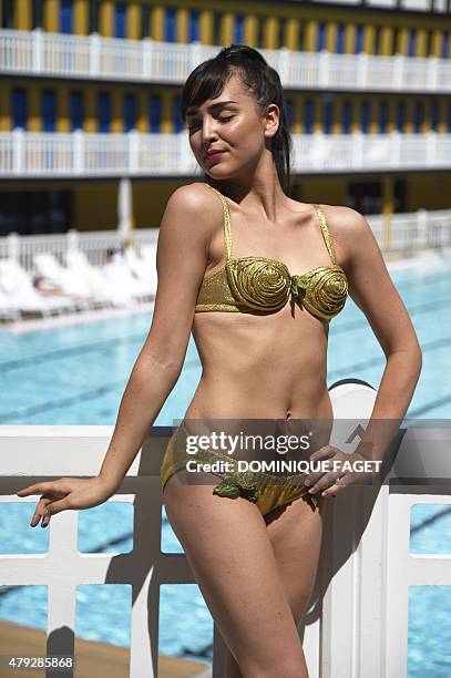 Model poses with the first Bikini of 1946 on June 29, 2015 at the Molitor swimming pool in Paris. On July 1 America performs the first of a series of...