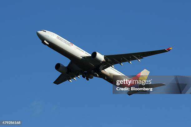 An Asiana Airlines Inc. Aircraft takes off from the Kansai International Airport in Izumisano City, Osaka, Japan, on Sunday, June 28, 2015. State-run...