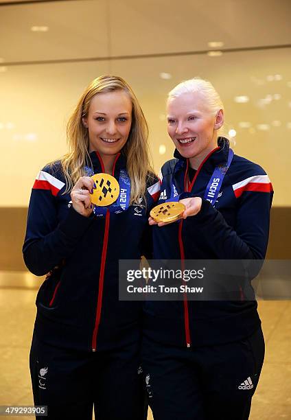 Charlotte Evans and Kelly Gallacher of Great Britain show off their Gold medal during the ParalympicsGB Welcome Home Press Conference at Heathrow...