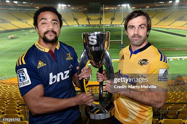 Captain of the Hurricanes Conrad Smith holds the Super 15 trophy with captain of the Highlanders Nasi Manu during the Super Rugby Final media...